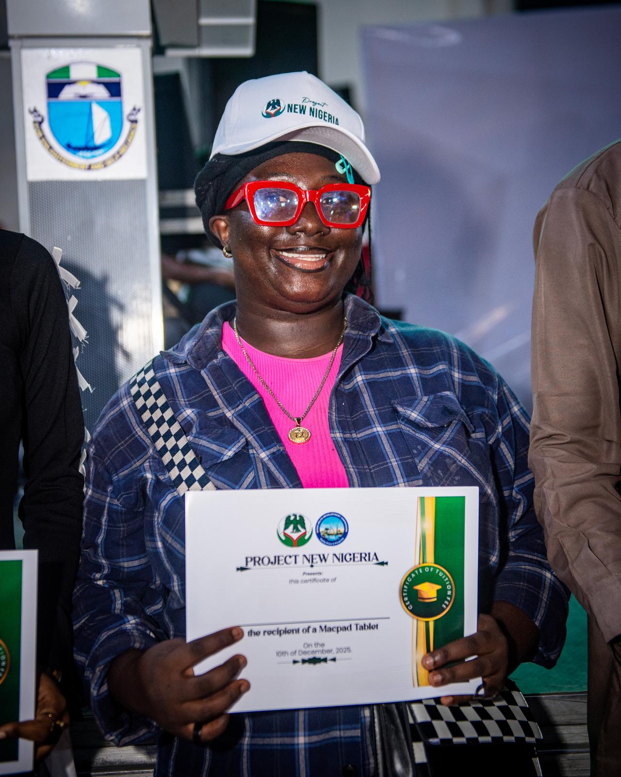 Scholarship beneficiary holding certificate