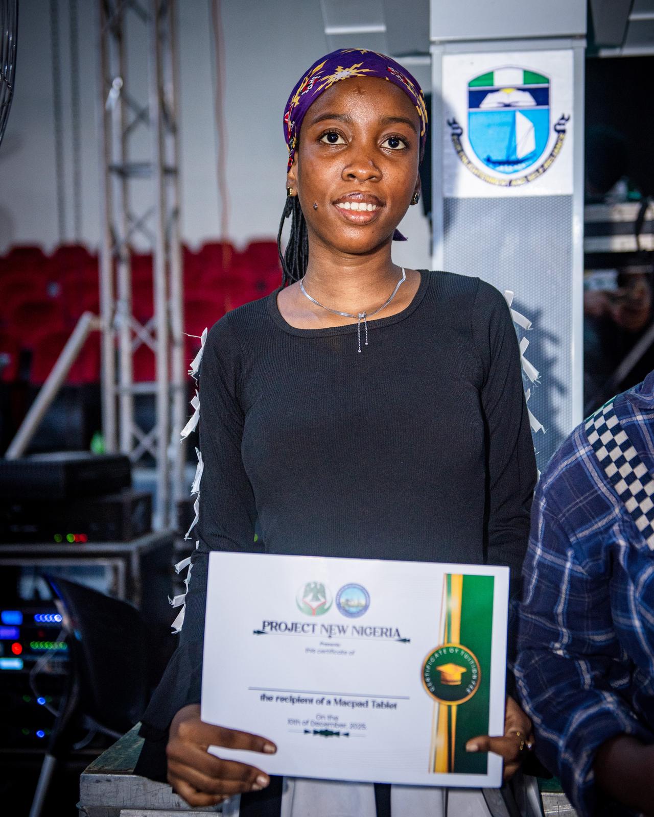 Scholarship beneficiary holding certificate