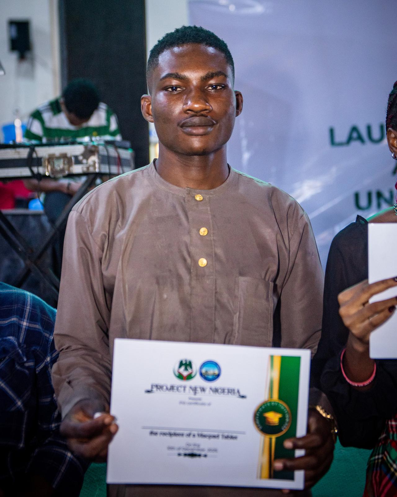 Scholarship beneficiary holding certificate