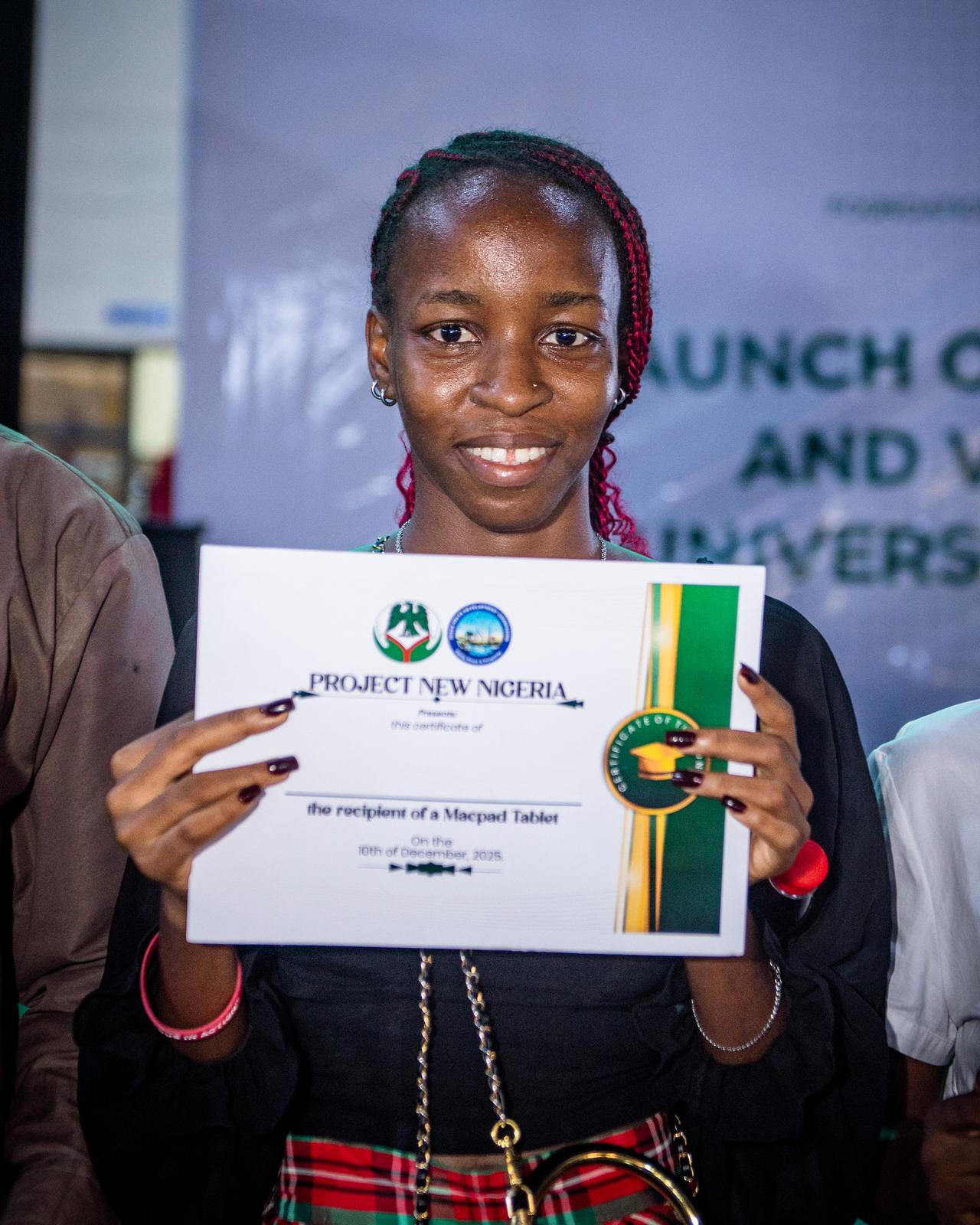 Scholarship beneficiary holding certificate
